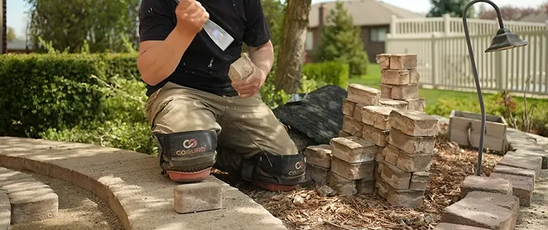 Man repairing brick paver walkway