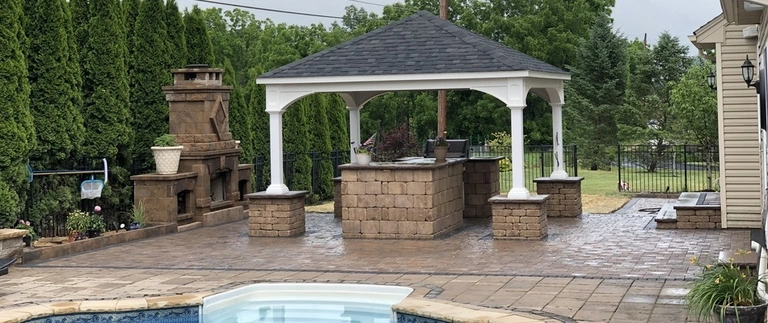 A custom built pavilion installed over an outdoor kitchen behind a home in Easton, PA.