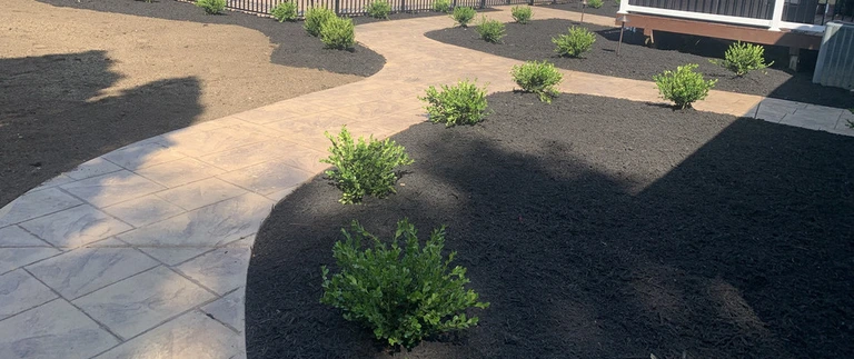 A custom built walkway surrounded by black mulch leading to our client's pool in Phillipsburg, NJ.