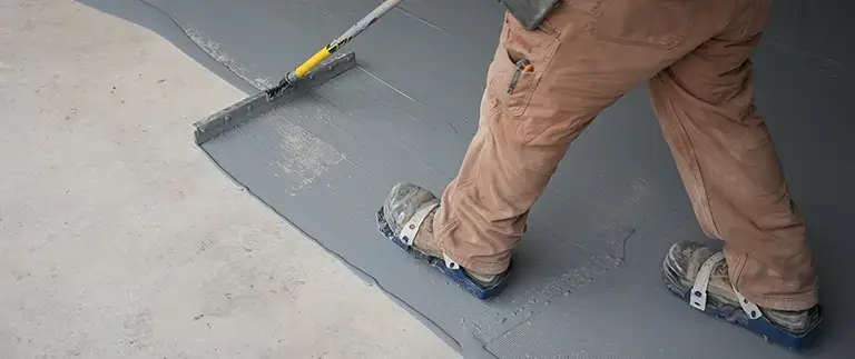 Man spreading epoxy on garage floor